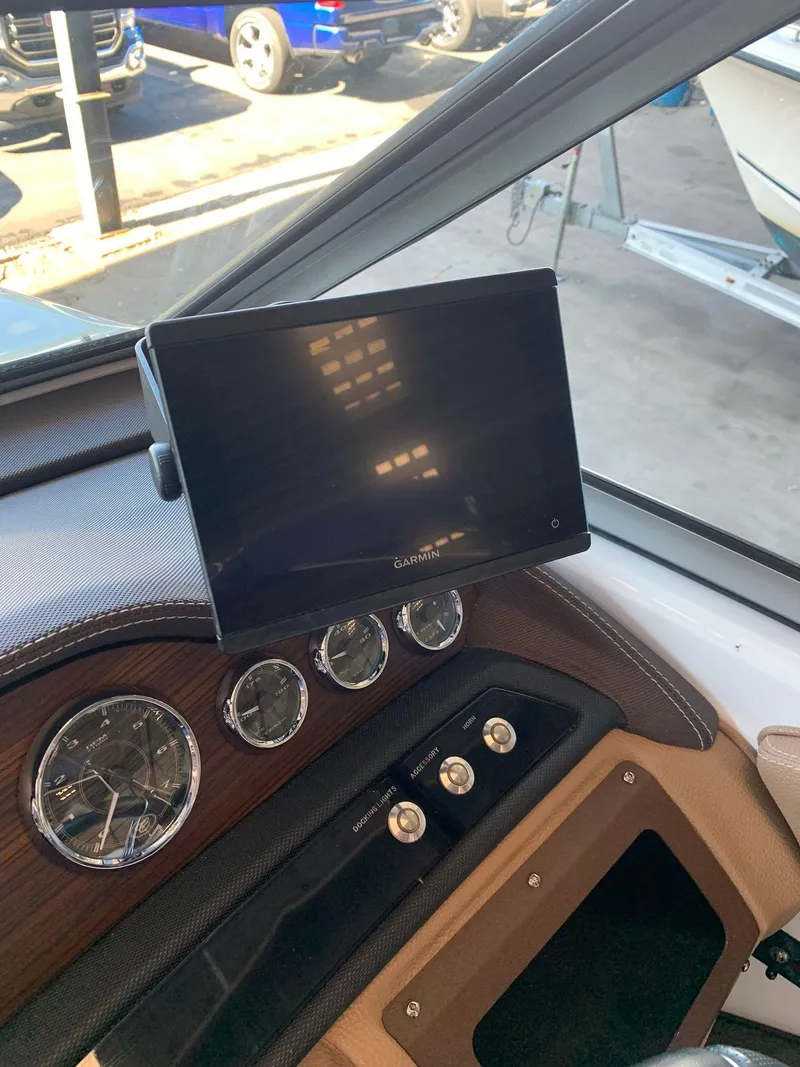 Slide: The Image of Dashboard of a 2015 Cobalt 243 boat with screen and gauges. - 30
