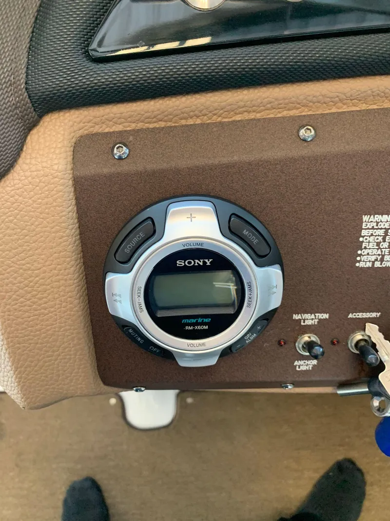 Slide: The Image of Sony marine stereo on 2015 Cobalt 243 boat dashboard. - 34
