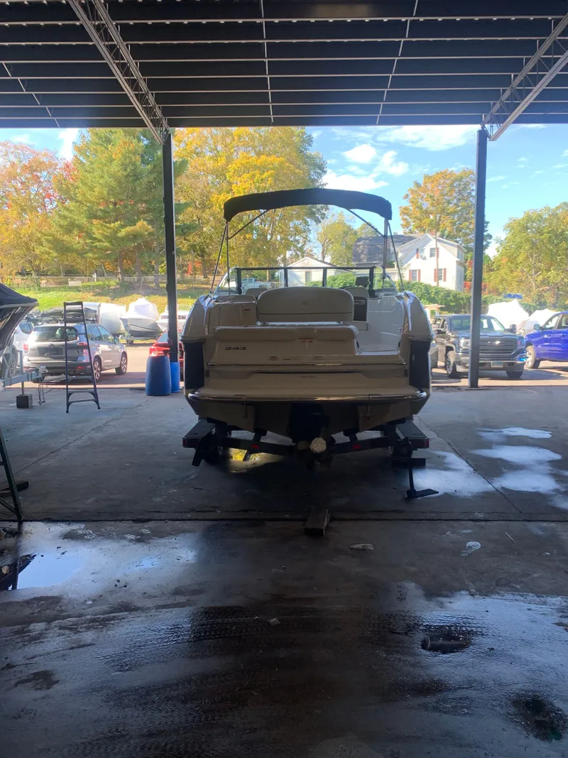 Slide: The Image of 2015 Cobalt 243 boat in a covered dockyard. - 4
