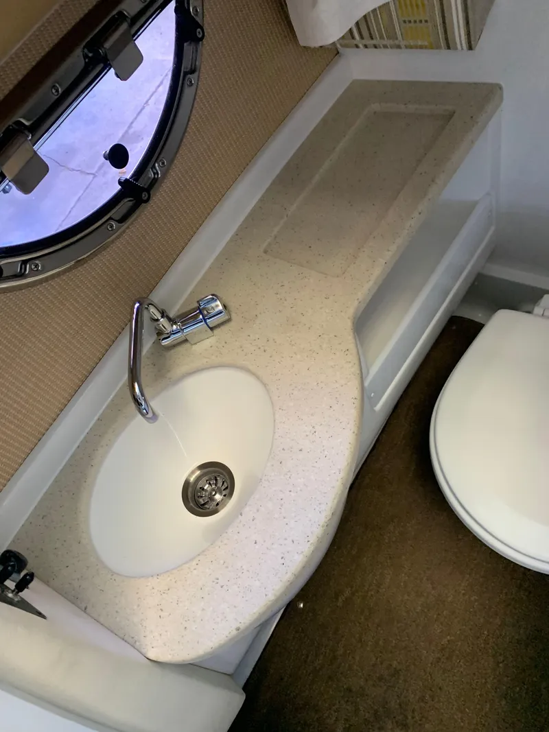 Slide: The Image of Sink and toilet in a 2015 Cobalt 243 yacht. - 42
