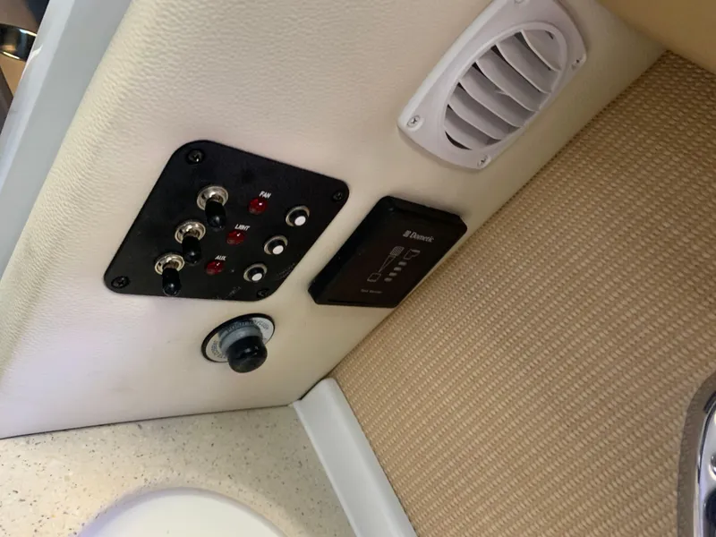 Slide: The Image of Control panel and speaker in 2015 Cobalt 243 boat. - 44