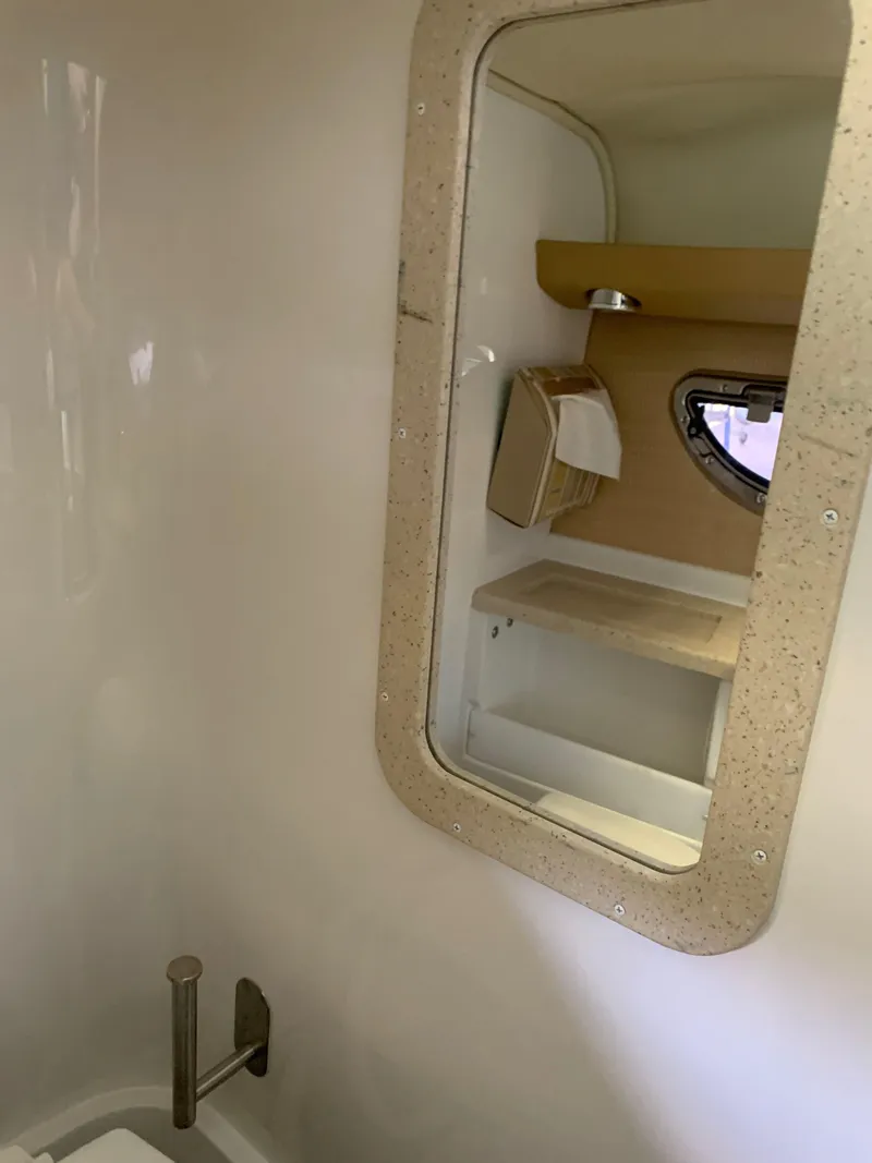 Slide: The Image of Interior of a 2015 Cobalt 243 boat with mirror and shelf. - 45