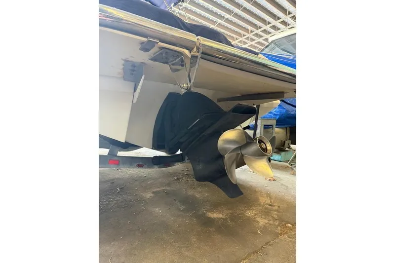 Slide: The Image of 2015 Cobalt 243 boat propeller and stern view in a covered storage area. - 55