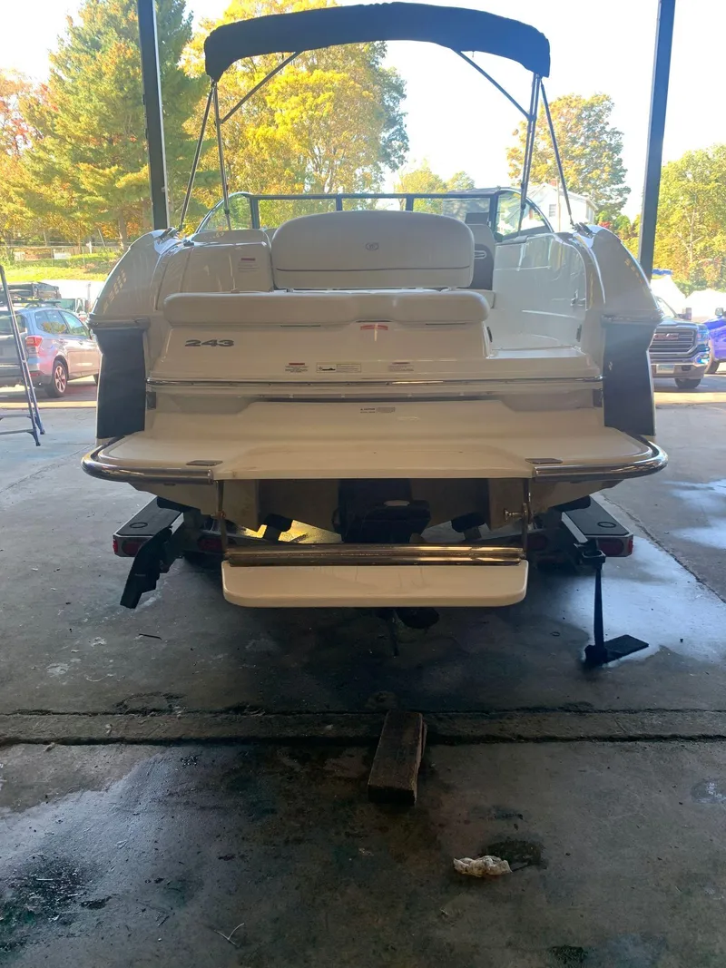 Slide: The Image of Rear view of a 2015 Cobalt 243 boat in a garage. - 7