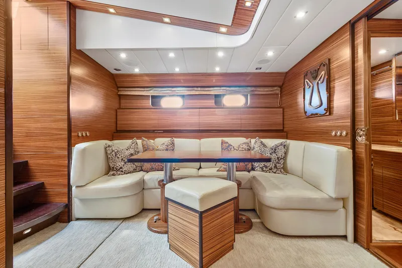 Slide: The Image of Luxurious 2007 Leopard Express Motor Yacht interior with elegant wood paneling and plush seating. - 24