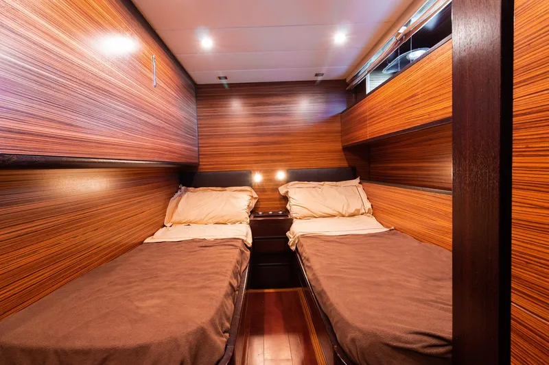 Slide: The Image of Luxurious twin cabin in 2007 Leopard Express Motor Yacht with wood paneling and ambient lighting. - 29