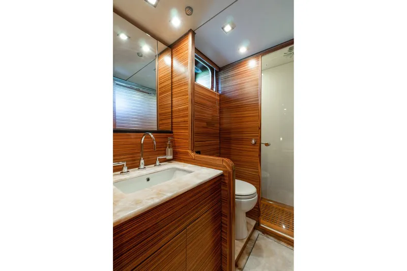 Slide: The Image of Luxurious 2007 Leopard Express Motor Yacht bathroom with wood paneling and modern fixtures. - 30