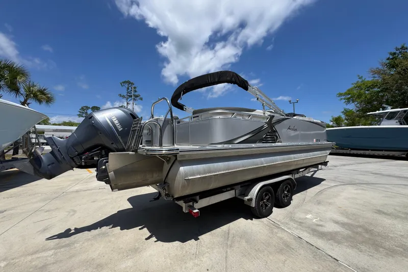 Slide: The Image of 2021 Avalon LSZ 2485 QL pontoon boat with Yamaha outboard motor on trailer. - 12