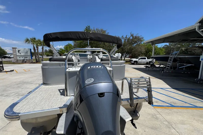 Slide: The Image of 2021 Avalon LSZ 2485 QL pontoon boat with 150 HP engine at marina. - 15