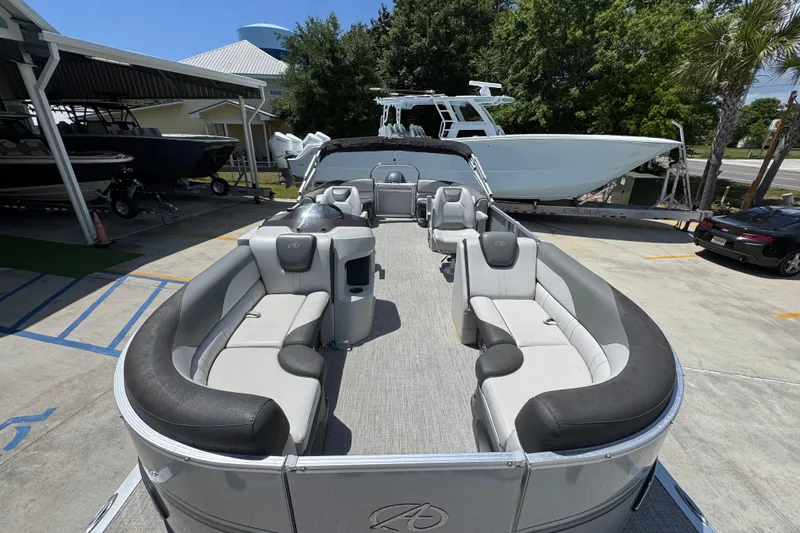 Slide: The Image of 2021 Avalon LSZ 2485 QL pontoon boat with spacious seating, parked outdoors. - 19