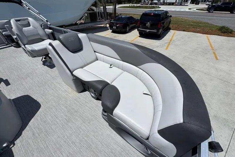 Slide: The Image of 2021 Avalon LSZ 2485 QL pontoon boat with stylish seating in a parking lot. - 21