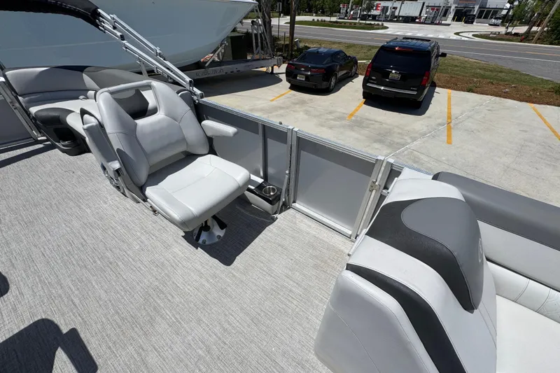 Slide: The Image of 2021 Avalon LSZ 2485 QL pontoon boat interior with gray seating and cup holder. - 23