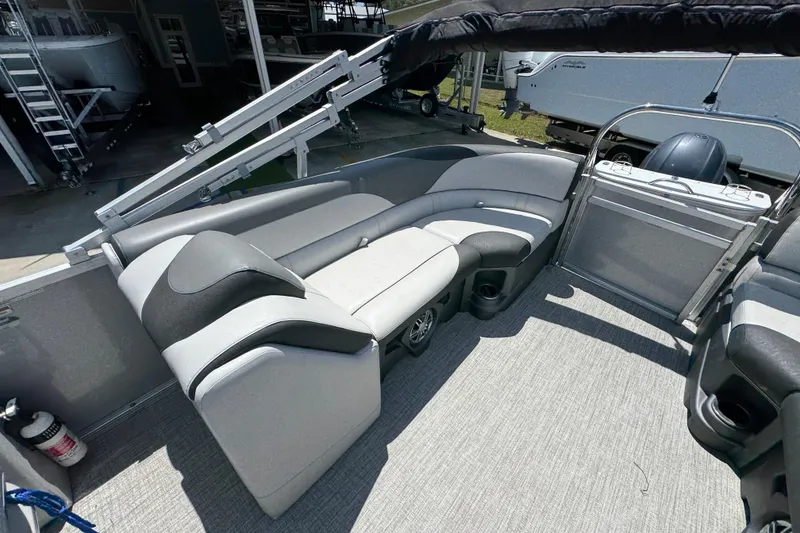 Slide: The Image of Interior of 2021 Avalon LSZ 2485 QL pontoon boat with gray seating and flooring. - 28