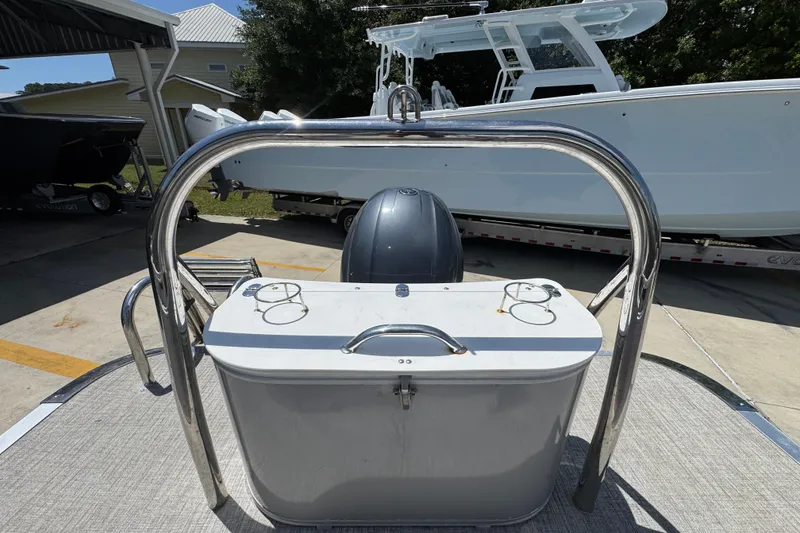 Slide: The Image of 2021 Avalon LSZ 2485 QL pontoon boat with stainless steel railing and motor, docked outdoors. - 30
