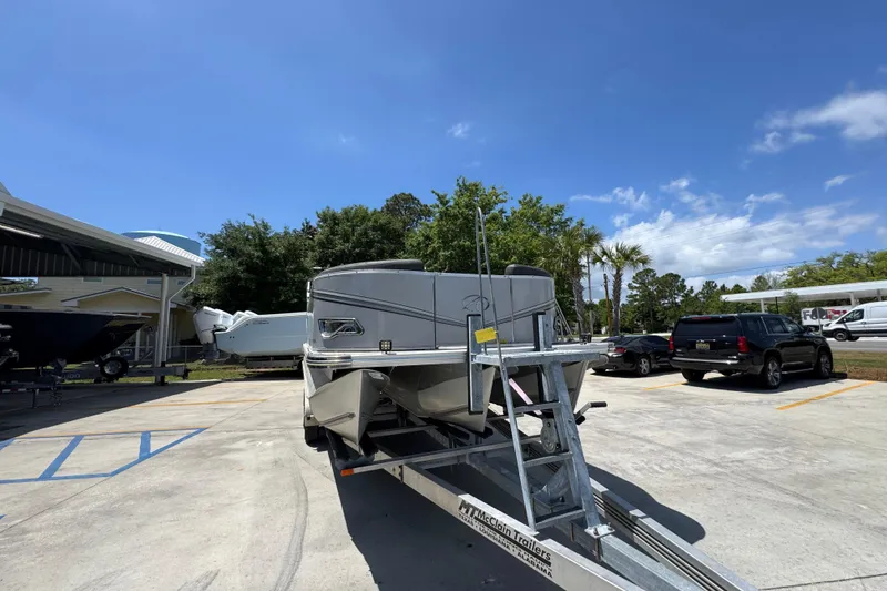 Slide: The Image of 2021 Avalon LSZ 2485 QL pontoon boat on trailer in sunny parking lot. - 7
