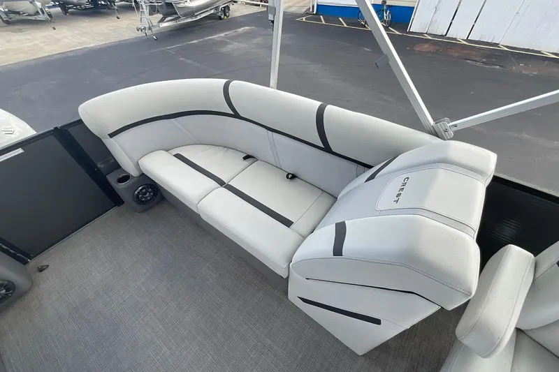Slide: The Image of 2023 Crest Classic LX 200 SLC pontoon boat interior with plush seating. - 11