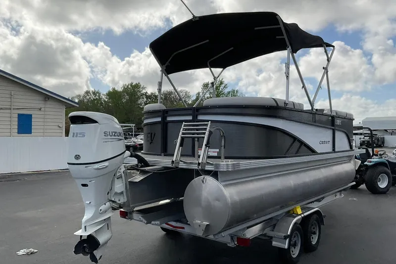 Slide: The Image of 2023 Crest Classic LX 200 SLC pontoon boat with Suzuki 115 outboard motor on trailer. - 4