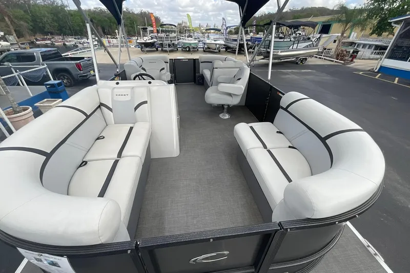 Slide: The Image of 2023 Crest Classic LX 200 SLC pontoon boat interior with plush seating and modern design. - 6