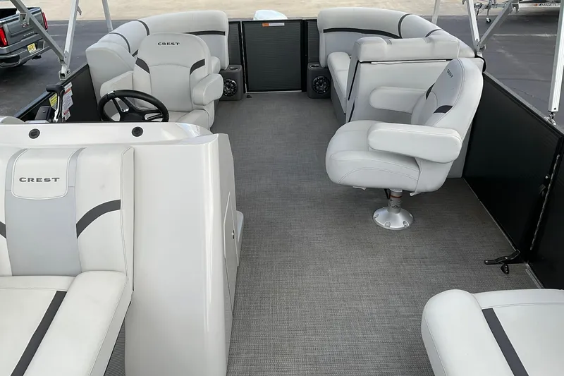 Slide: The Image of 2023 Crest Classic LX 200 SLC pontoon boat interior with plush seating and modern design. - 7