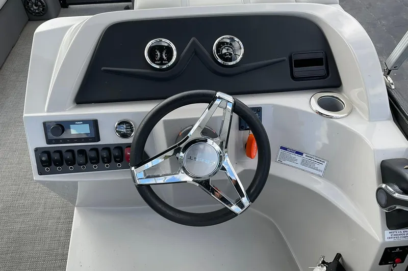 Slide: The Image of 2023 Crest Classic LX 200 SLC boat dashboard with steering wheel and controls. - 9