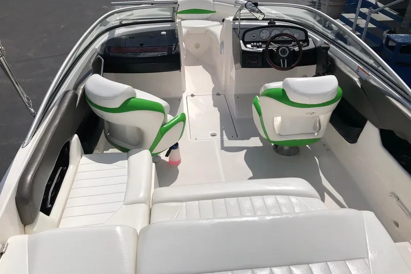 Slide: The Image of 2008 Regal 2000 Bowrider interior with white and green seating, steering wheel, and dashboard. - 10