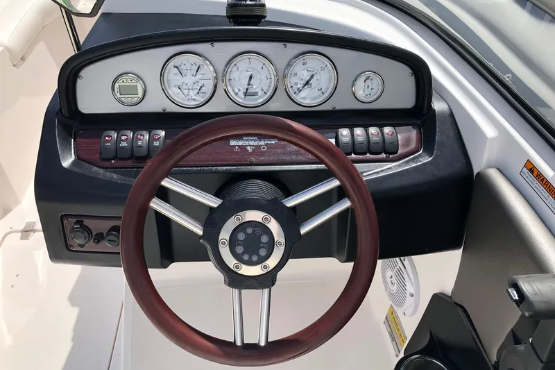 Slide: The Image of Dashboard of a 2008 Regal 2000 Bowrider boat with gauges and steering wheel. - 11