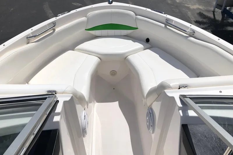 Slide: The Image of 2008 Regal 2000 Bowrider boat interior with white seating and green accent. - 13