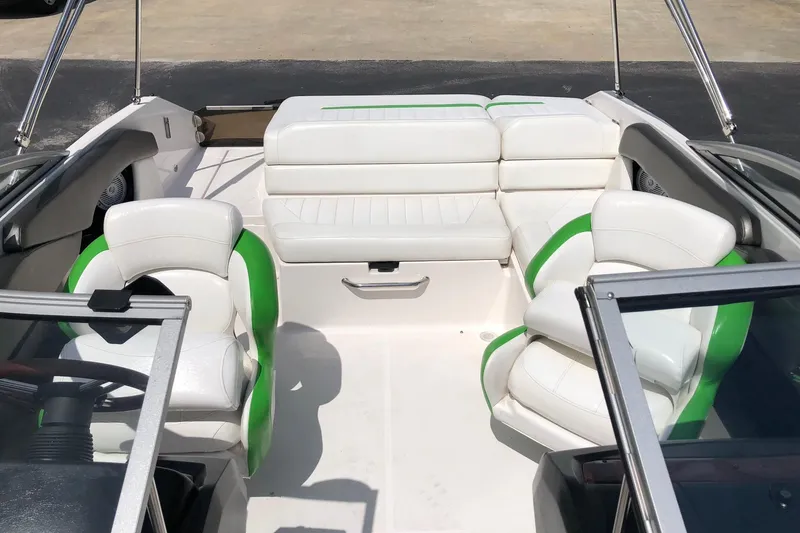 Slide: The Image of 2008 Regal 2000 Bowrider interior with white and green seating, open deck layout. - 15