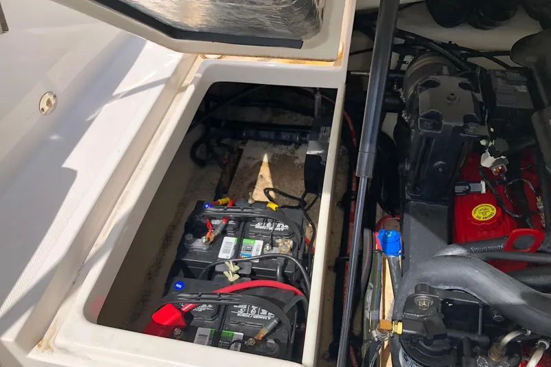 Slide: The Image of Battery compartment of a 2008 Regal 2000 Bowrider boat, showing dual batteries and engine components. - 17