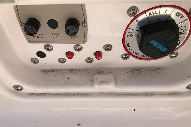 Slide: The Image of Control panel of a 2008 Regal 2000 Bowrider boat with switches and Perko dial. - 19
