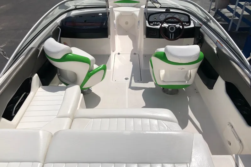 Slide: The Image of 2008 Regal 2000 Bowrider interior with white and green seating, steering wheel, and dashboard. - 20