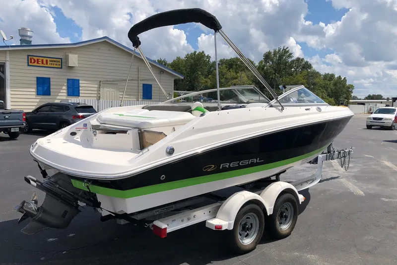 Slide: The Image of 2008 Regal 2000 Bowrider boat on trailer, parked near a deli. - 6