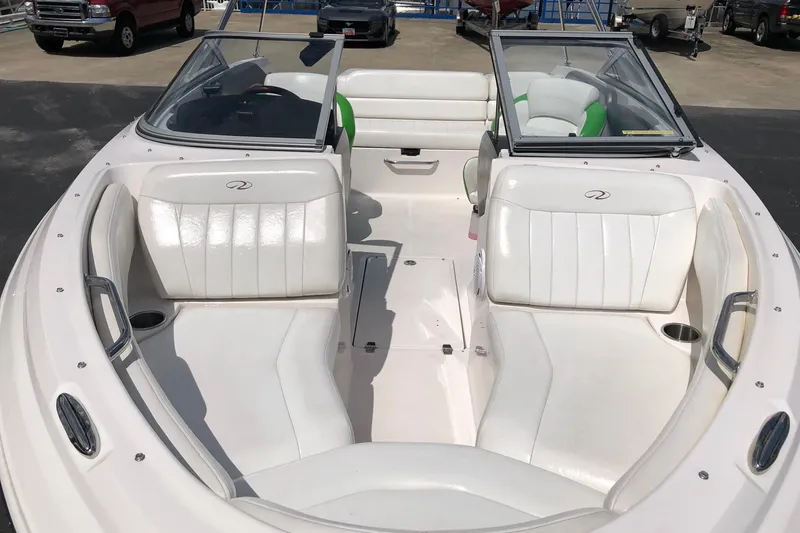 Slide: The Image of 2008 Regal 2000 Bowrider boat with white seating and open deck layout. - 9