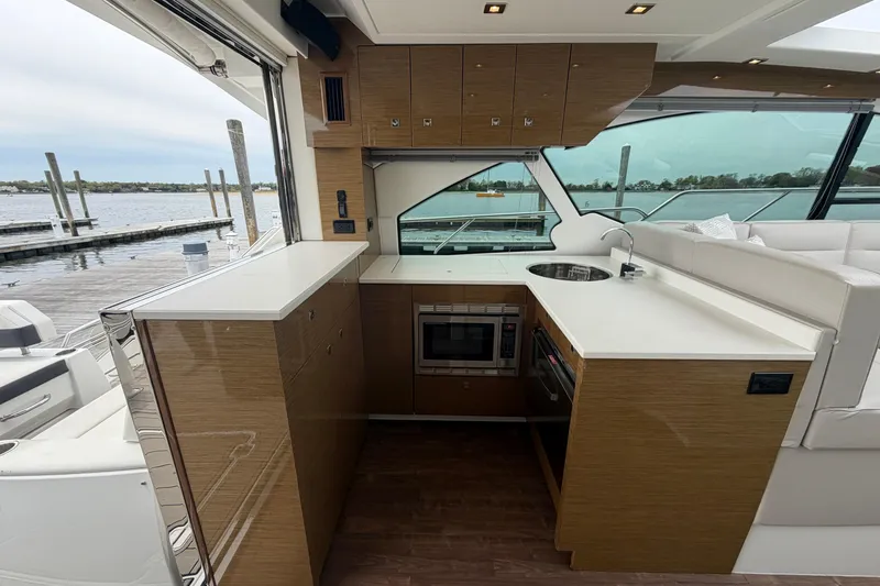 Slide: The Image of Luxurious 2018 Cruisers Yachts 50 Cantius interior kitchen with modern amenities and waterfront view. - 11