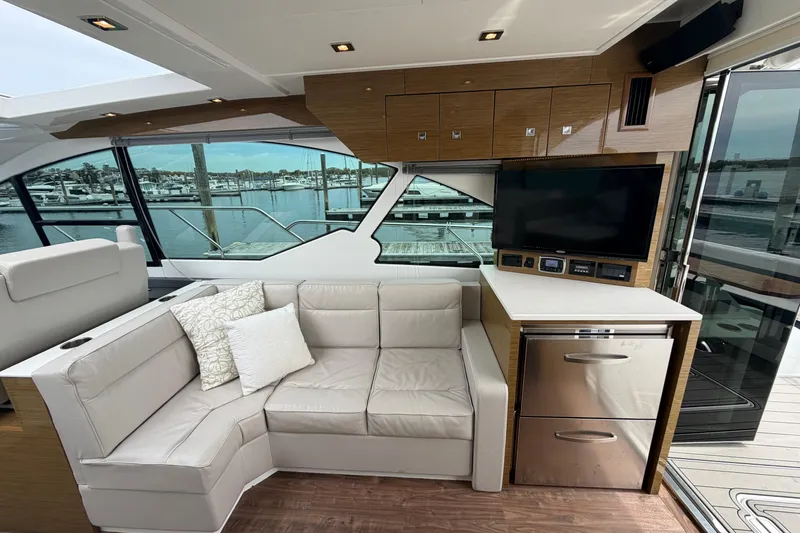 Slide: The Image of Luxurious interior of 2018 Cruisers Yachts 50 Cantius with leather seating and waterfront view. - 12