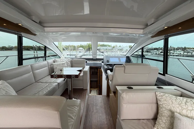 Slide: The Image of Luxurious interior of 2018 Cruisers Yachts 50 Cantius with plush seating and panoramic windows. - 14
