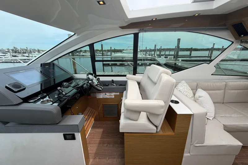Slide: The Image of Interior of 2018 Cruisers Yachts 50 Cantius with helm and seating area. - 16