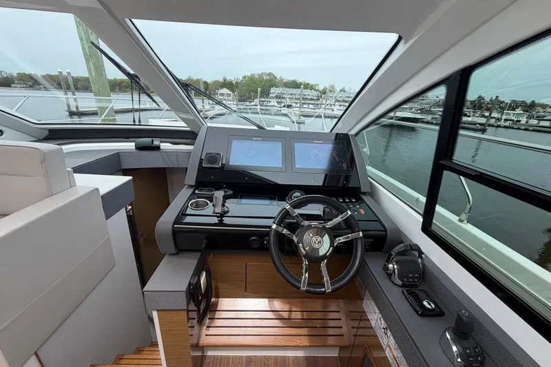 Slide: The Image of Helm of 2018 Cruisers Yachts 50 Cantius with modern navigation displays and steering wheel. - 17