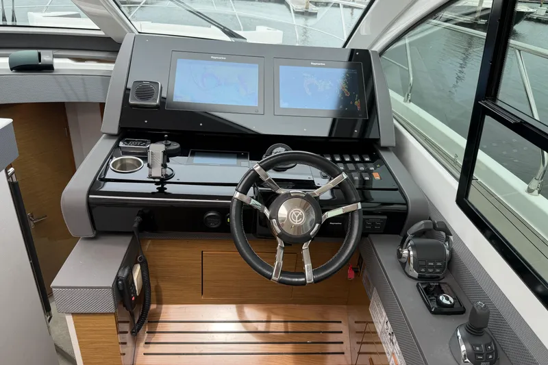 Slide: The Image of Helm of 2018 Cruisers Yachts 50 Cantius with dual navigation screens and modern controls. - 18