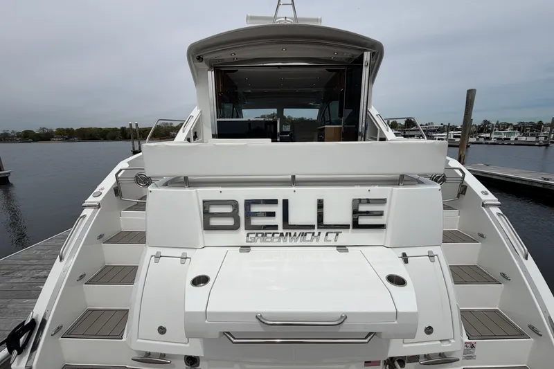 Slide: The Image of 2018 Cruisers Yachts 50 Cantius docked, rear view with "BELLE" nameplate. - 2