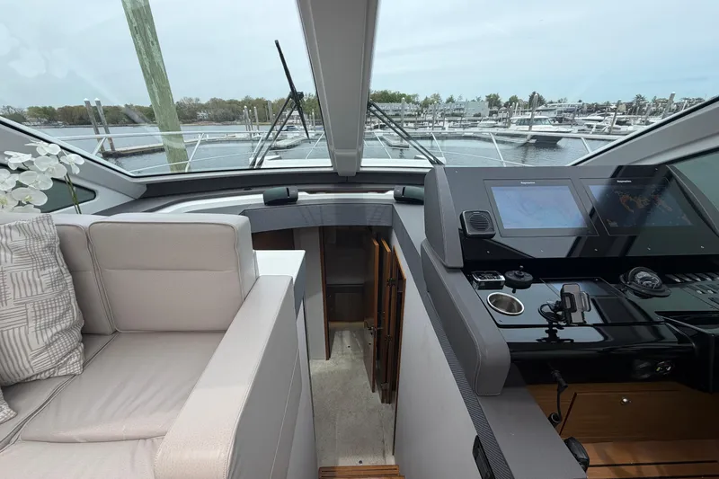 Slide: The Image of Interior view of 2018 Cruisers Yachts 50 Cantius helm with modern navigation equipment. - 20