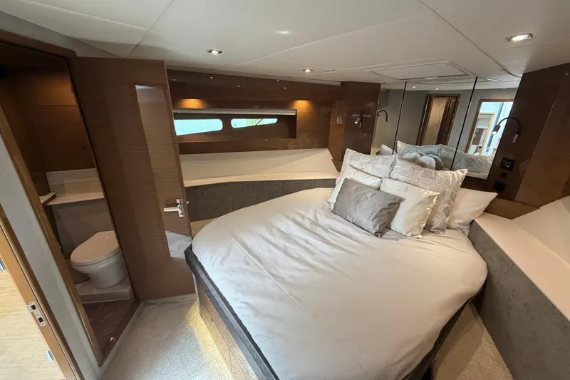 Slide: The Image of Luxurious bedroom interior of 2018 Cruisers Yachts 50 Cantius with elegant bedding and ensuite bathroom. - 25