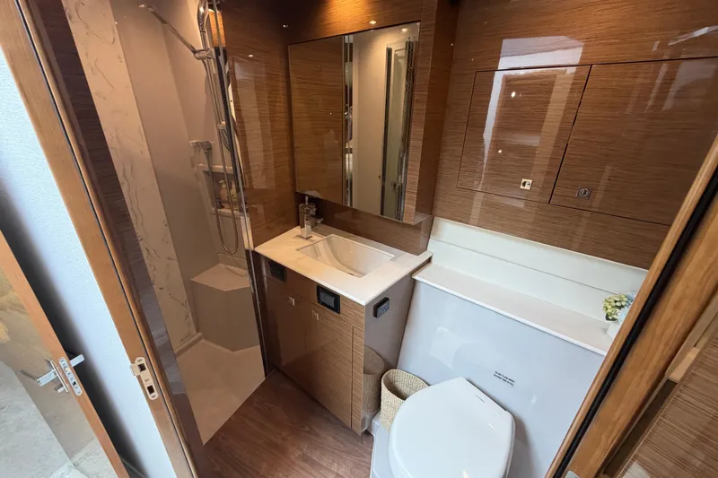 Slide: The Image of Luxurious bathroom in 2018 Cruisers Yachts 50 Cantius with modern fixtures and wood accents. - 28