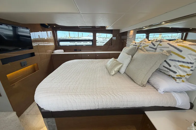 Slide: The Image of Luxurious bedroom interior of 2018 Cruisers Yachts 50 Cantius with elegant bedding and window view. - 37