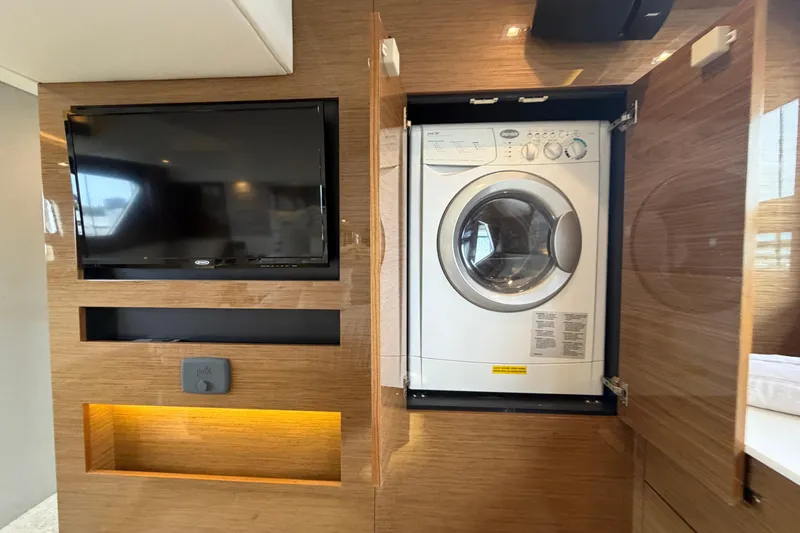 Slide: The Image of 2018 Cruisers Yachts 50 Cantius interior with TV and built-in washer. - 44
