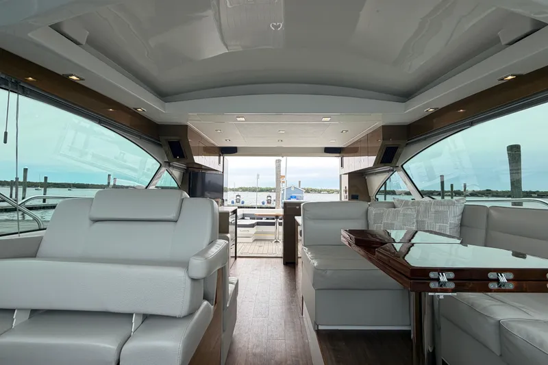 Slide: The Image of Luxurious interior of 2018 Cruisers Yachts 50 Cantius with elegant seating and panoramic windows. - 49