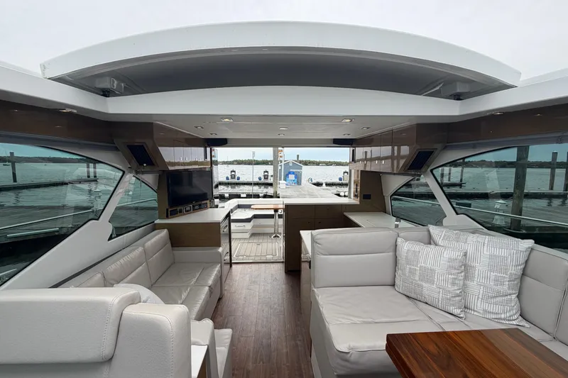 Slide: The Image of Luxurious interior of 2018 Cruisers Yachts 50 Cantius with elegant seating and waterfront view. - 50