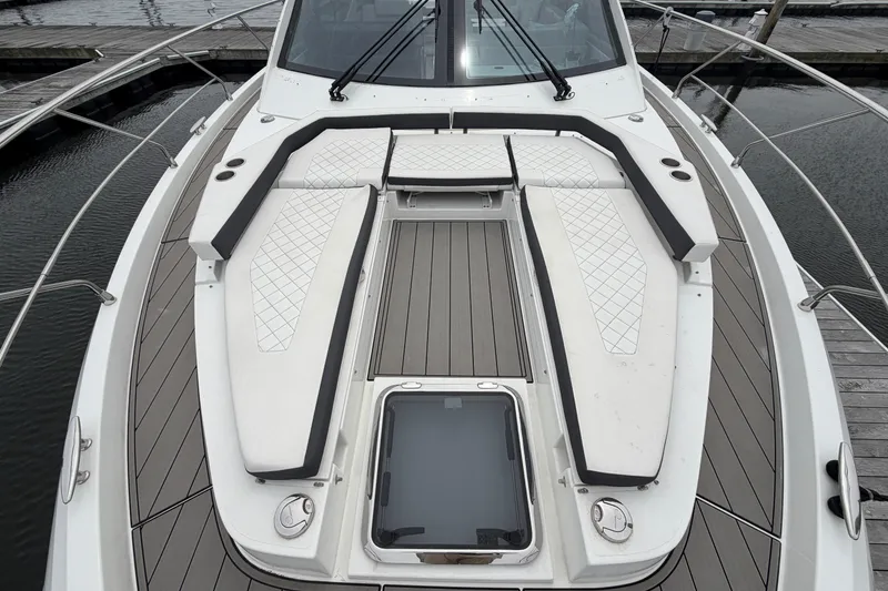 Slide: The Image of 2018 Cruisers Yachts 50 Cantius deck with cushioned seating and sleek design. - 57