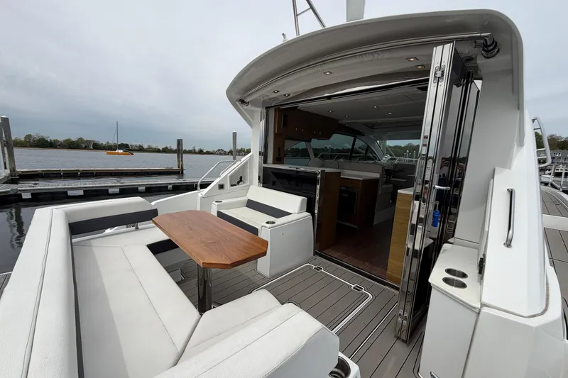 Slide: The Image of 2018 Cruisers Yachts 50 Cantius with elegant outdoor seating and open interior view. - 6