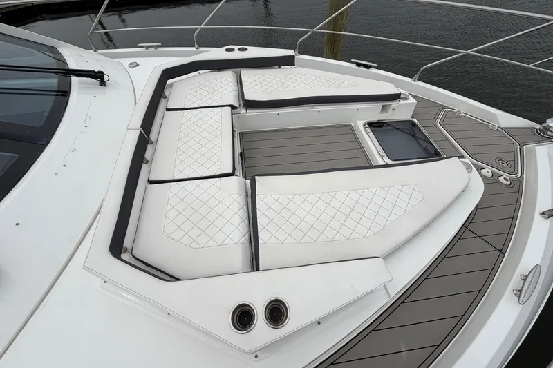 Slide: The Image of 2018 Cruisers Yachts 50 Cantius deck with luxurious white seating and sleek design. - 61